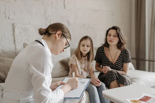 Clinician listening attentively during a patient consultation