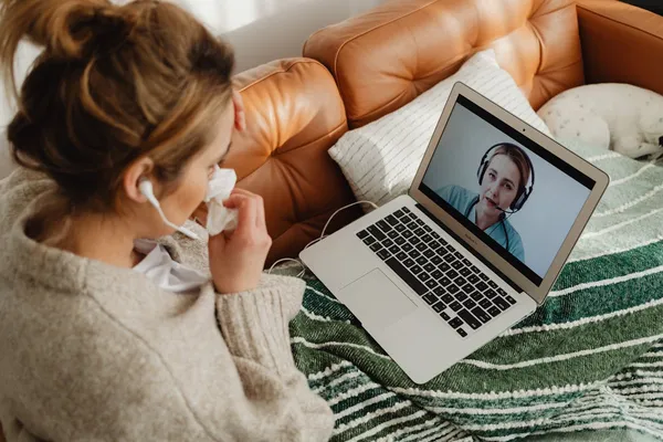 Healthcare professional reviewing notes during a telehealth session